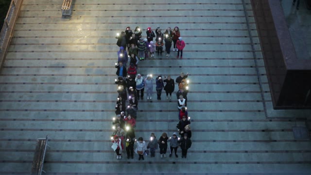 Crowd Standing In The Form Of Letters