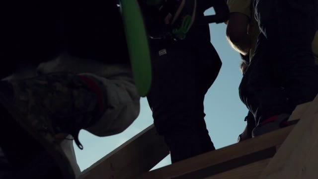 Man With A Snowboard Climbing Stairs