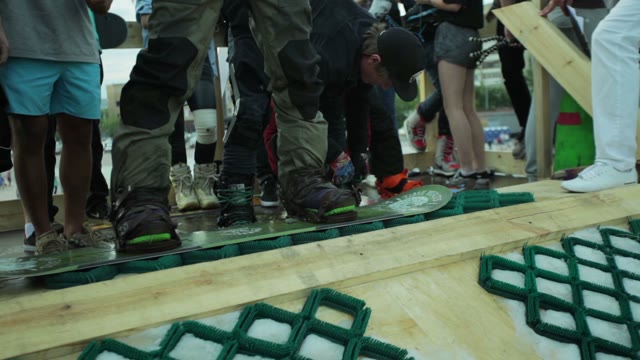 Man Getting Ready To Move Out On A Snowboard Close-up