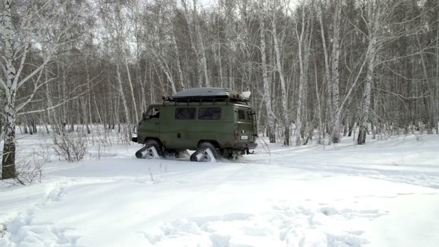 Snowmobile Rides Through Deep Snowdrifts In The Winter Woods
