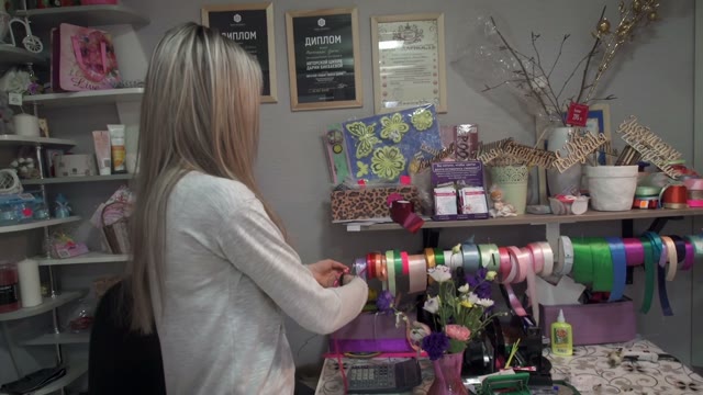 Girl Prepares A Gift Wrapping Ribbon