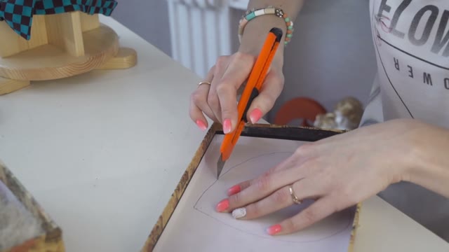 Girl Cuts A Stencil Out Of Cardboard