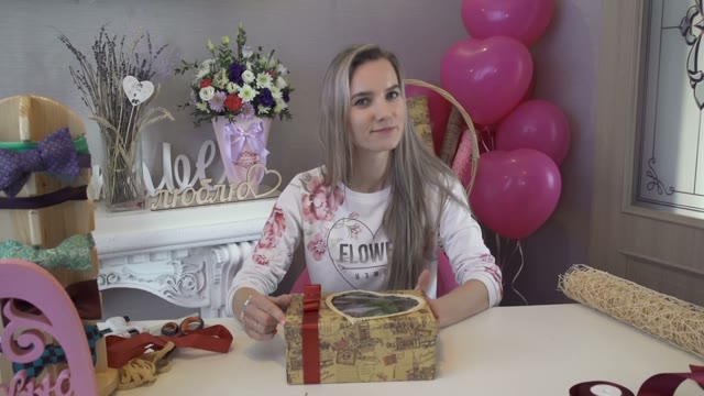 Beautiful Young Girl Holding A Gift And Looking Into The Camera