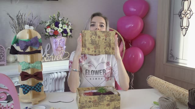 Girl Hides Her Face Behind A Sheet Of Cardboard