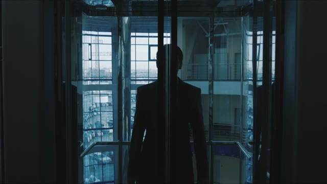 Businessman Out Of A Glass Elevator