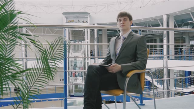 Businessman Sitting In A Chair In Mall