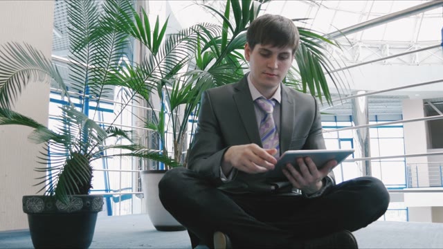 Businessman Working With A Tablet In A Business Center