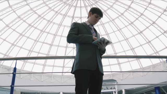 Businessman With A Tablet In Hands In The Mall