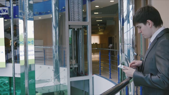 Businessman With A Tablet In Shopping Center