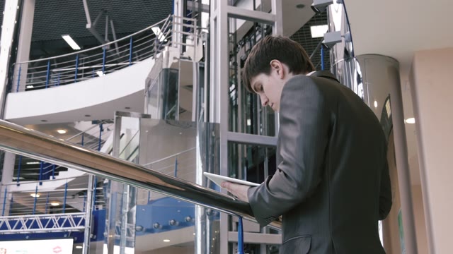 Businessman With A Tablet In His Hand In Shopping Center