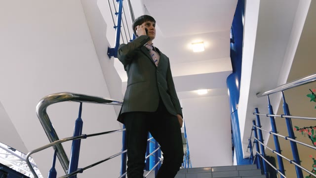 Businessman Talking On The Phone On The Stairs
