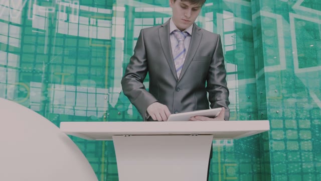 Businessman Behind The Podium With The Tablet