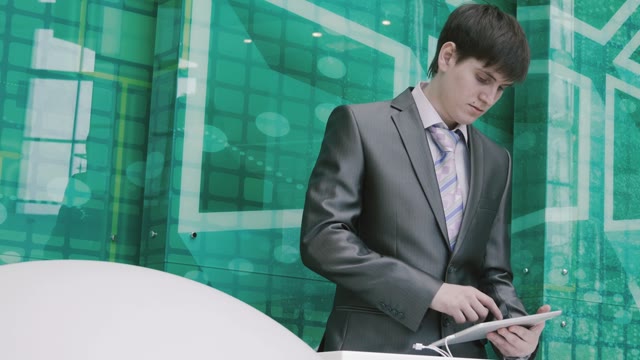 Businessman Behind The Podium Working On The Tablet