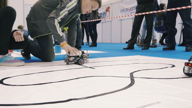 Robots Go On The Path Drawn On The Floor In The Science Fair
