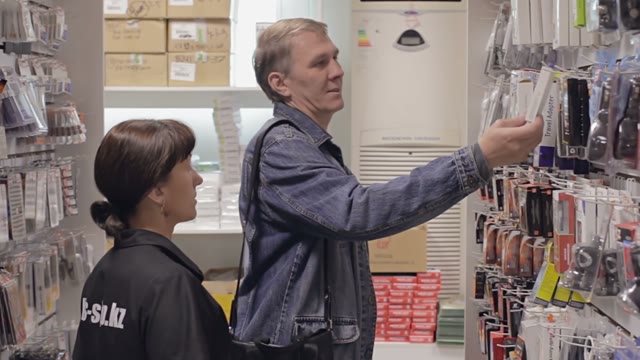Seller Helps The Buyer To Choose The Goods In The Shop Of Accessories