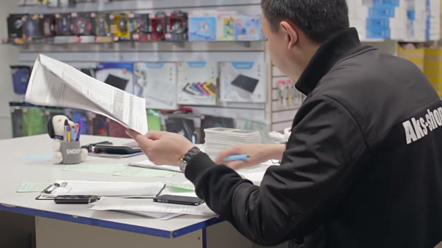Man Holds An Inventory Of Equipment In The Shop