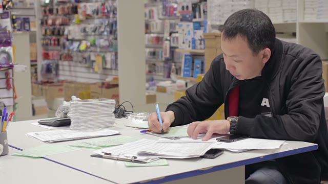 Man Holds An Inventory Of Equipment In The Shop