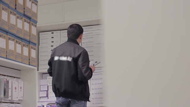 Man Holds An Inventory Of Equipment In The Shop