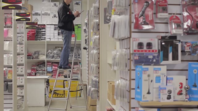 Man Holds An Inventory Of Equipment In The Shop