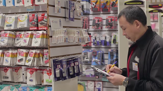 Shopkeeper Holds An Inventory Of Equipment In The Shop