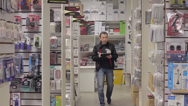 Shopkeeper Holds An Inventory Of Equipment In The Shop