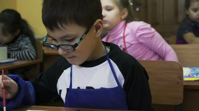 Small Children On Creative Lesson In Primary Class