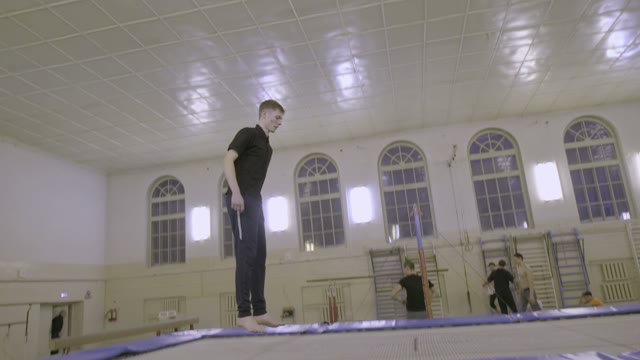 Man Jumping On The Trampoline In The Sports Class