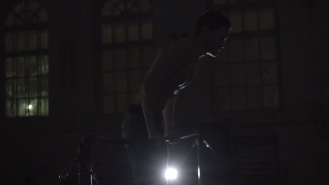 Young Man Is Engaged On The Bar In The Sports Class