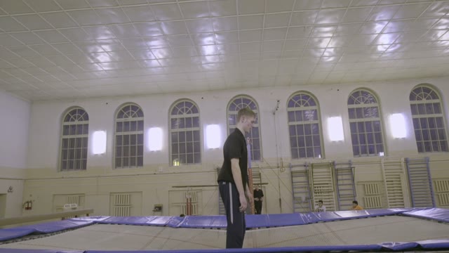 Man Jumping On The Trampoline In The Sports Class