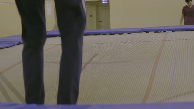Man Jumping On The Trampoline In The Sports Class