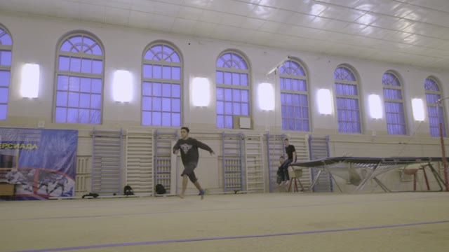 Man Jumping On The Trampoline In The Sports Class