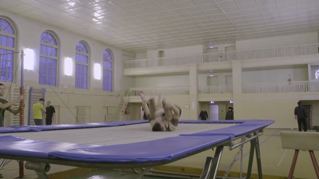 Man Jumping On The Trampoline In The Sports Class