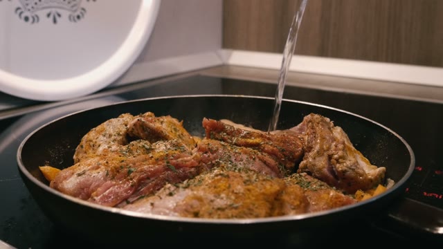 Frying Meat In A Pan On An Electric Stove