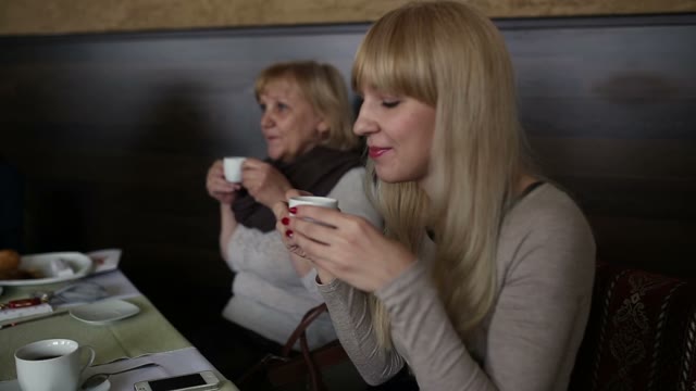 Women In The Coffee Bar At The Table Enjoying A Cup Of Fine Drink