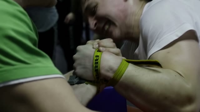 Men Practicing Arm Wrestling In The Gym