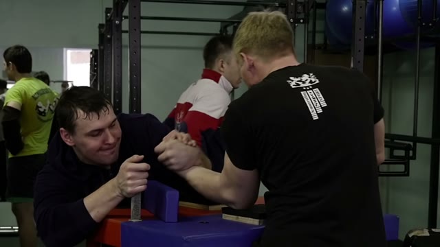 Men Practicing Arm Wrestling In The Gym
