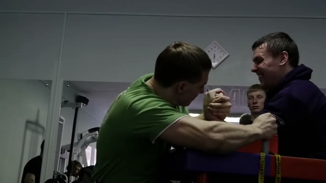 Men Practicing Arm Wrestling In The Gym