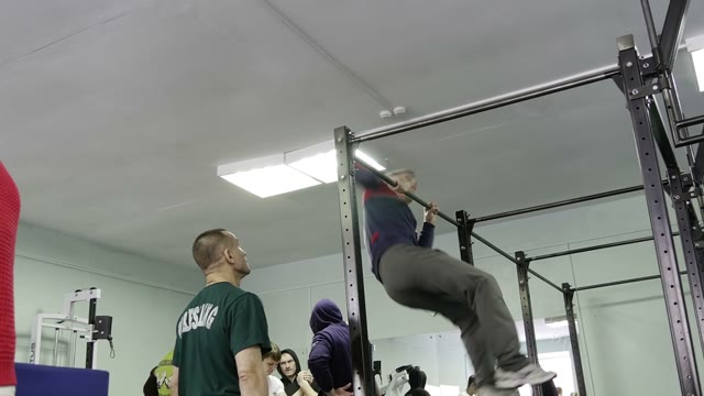 Man Doing Exercises On The Horizontal Bar In The Gym