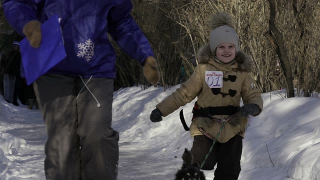 Children Competition Running With Their Dogs In Winter