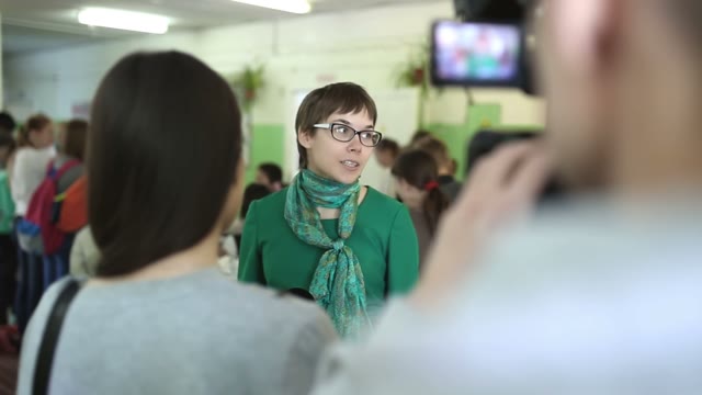 Woman With Glasses Gives An Interview In Front Of Camera