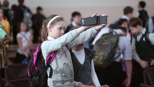 Girl Shoots A Video On A Cell Phone In The Classroom