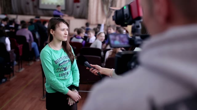 Girl Gives An Interview In Auditorium