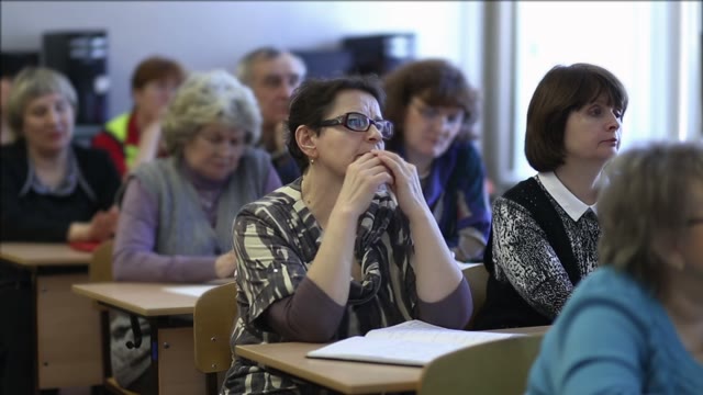 Females Listen To A Lecture Sitting In A Classroom