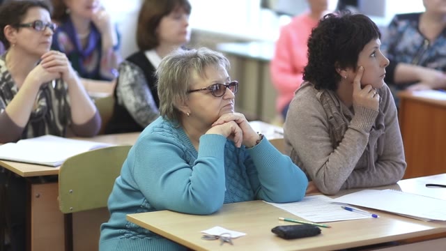 Females Listen To A Lecture Sitting In A Classroom