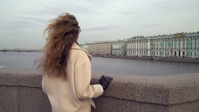 Cute Young Curly Girl Looks At The River