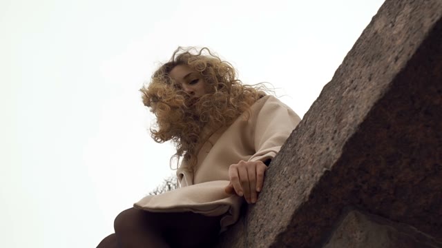 Cute Young Curly Girl Posing In Front Of The Camera