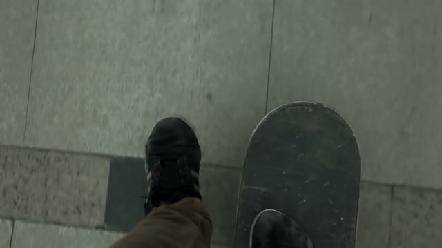 Skateboarder Rides On The Marble Pavement