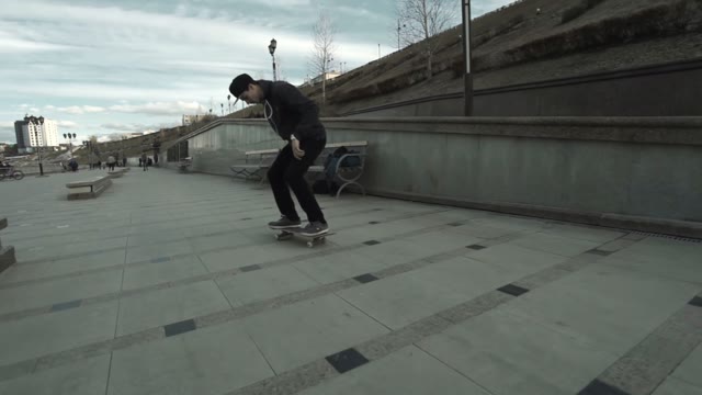 A Young Boy Performs A Trick On A Skateboard