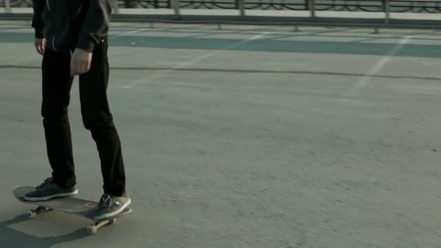 The Guy Goes On A Skateboard On A Slope Near The Motorway