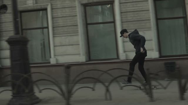 A Young Man Rides On His Skateboard On The City Streets